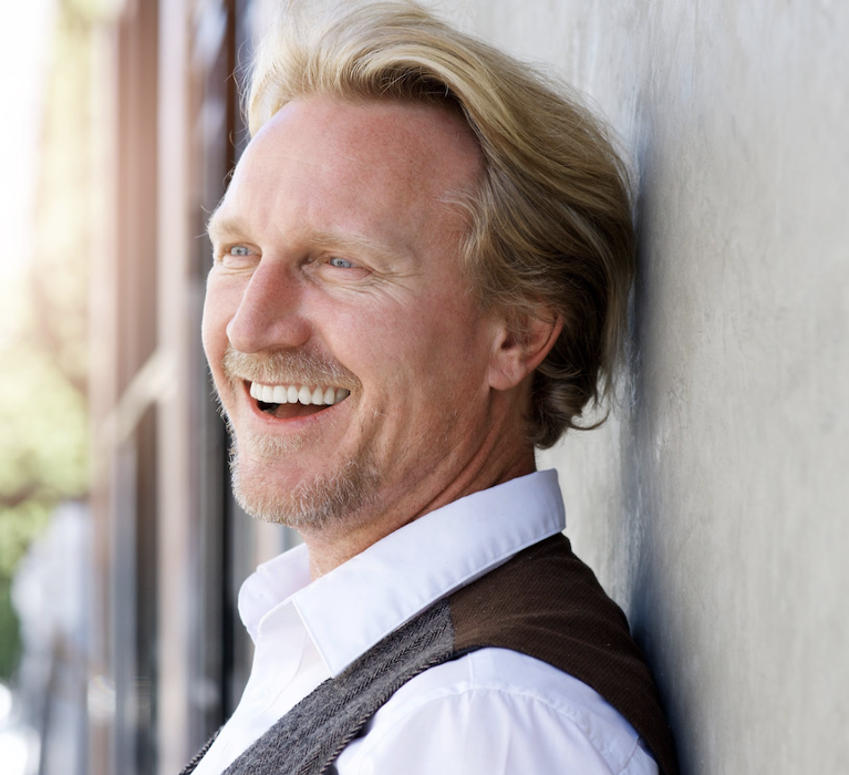 1. A smiling man, likely a dentist, promoting the benefits of root canal therapy.